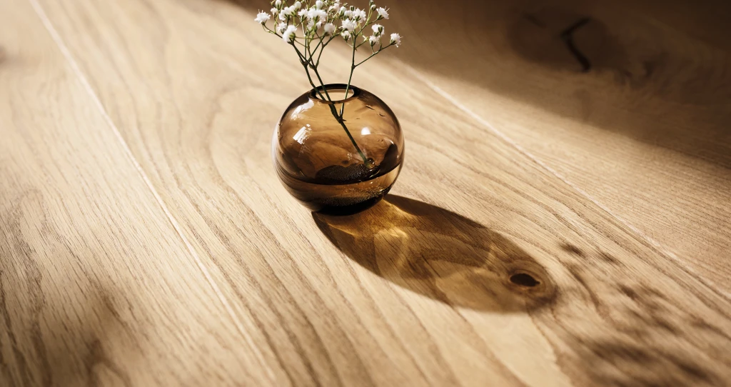 Elegant vase with a single branch, stylishly placed on a high-quality HARO parquet floor.