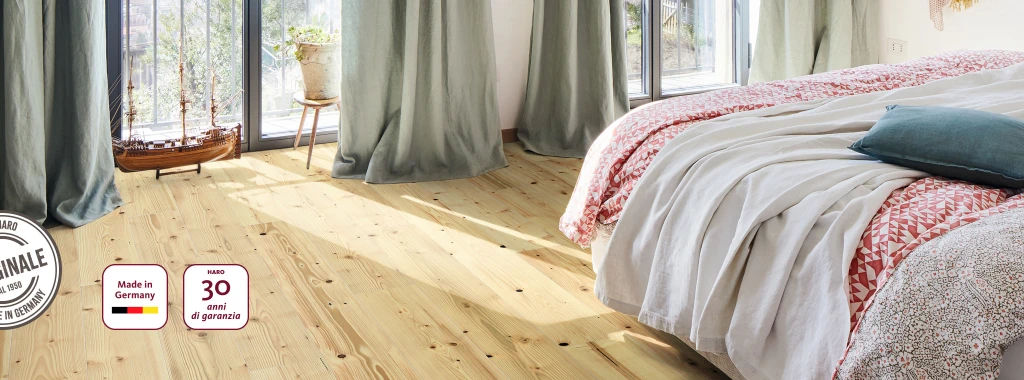 Una camera da letto con parquet in legno di abete HARO