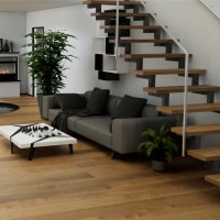 Amplio salón con suelo de parquet HARO marrón, instalado de forma uniforme también en la escalera.