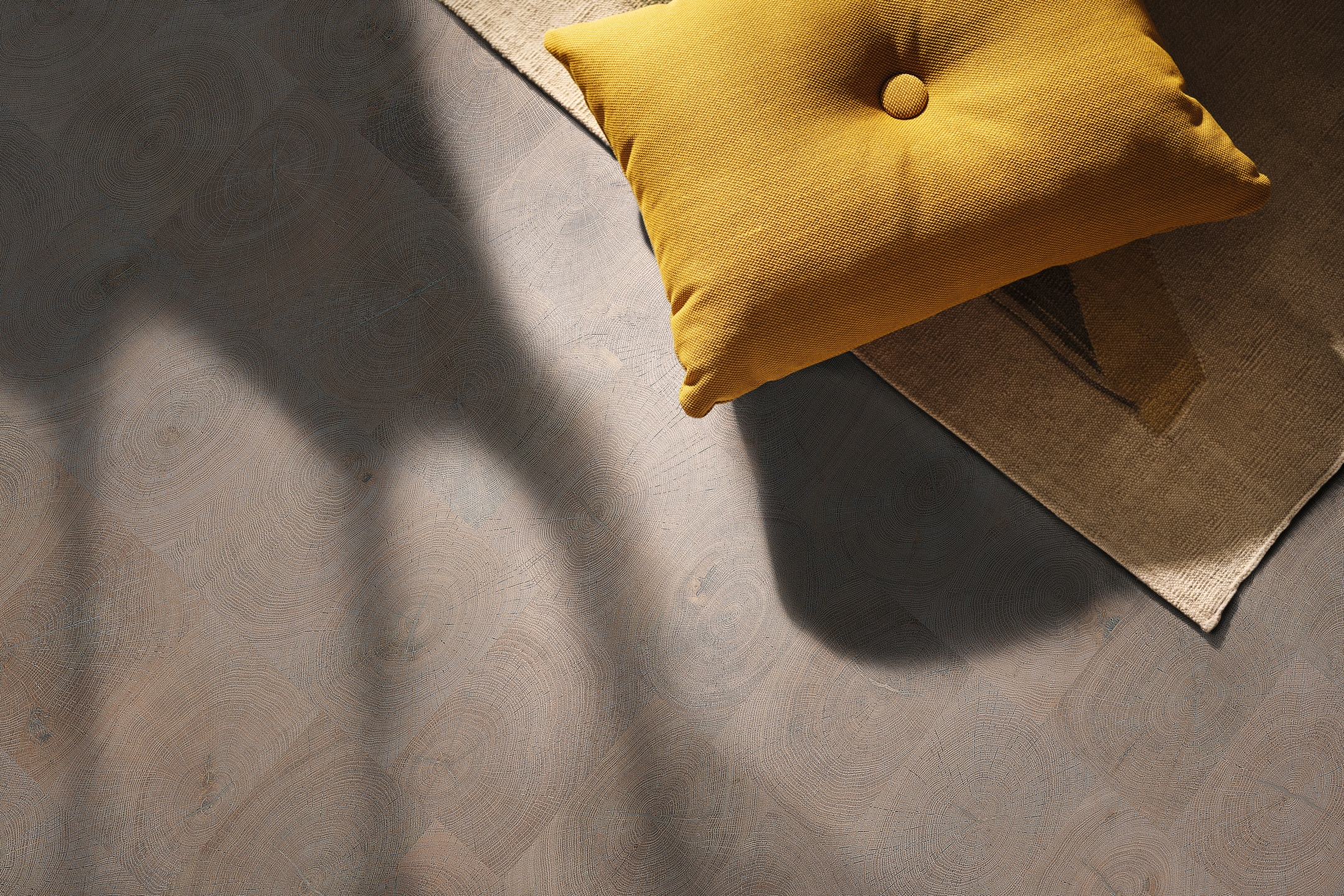 Nahaufnahme eines hochwertigen HARO parkettmanufaktur Parkettbodens, stilvoll akzentuiert durch ein halb sichtbares gelbes Kissen.