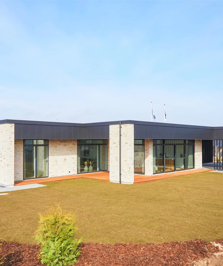 Bungalowen imponerer med sine store glasfronter og den lyse indgangshal.